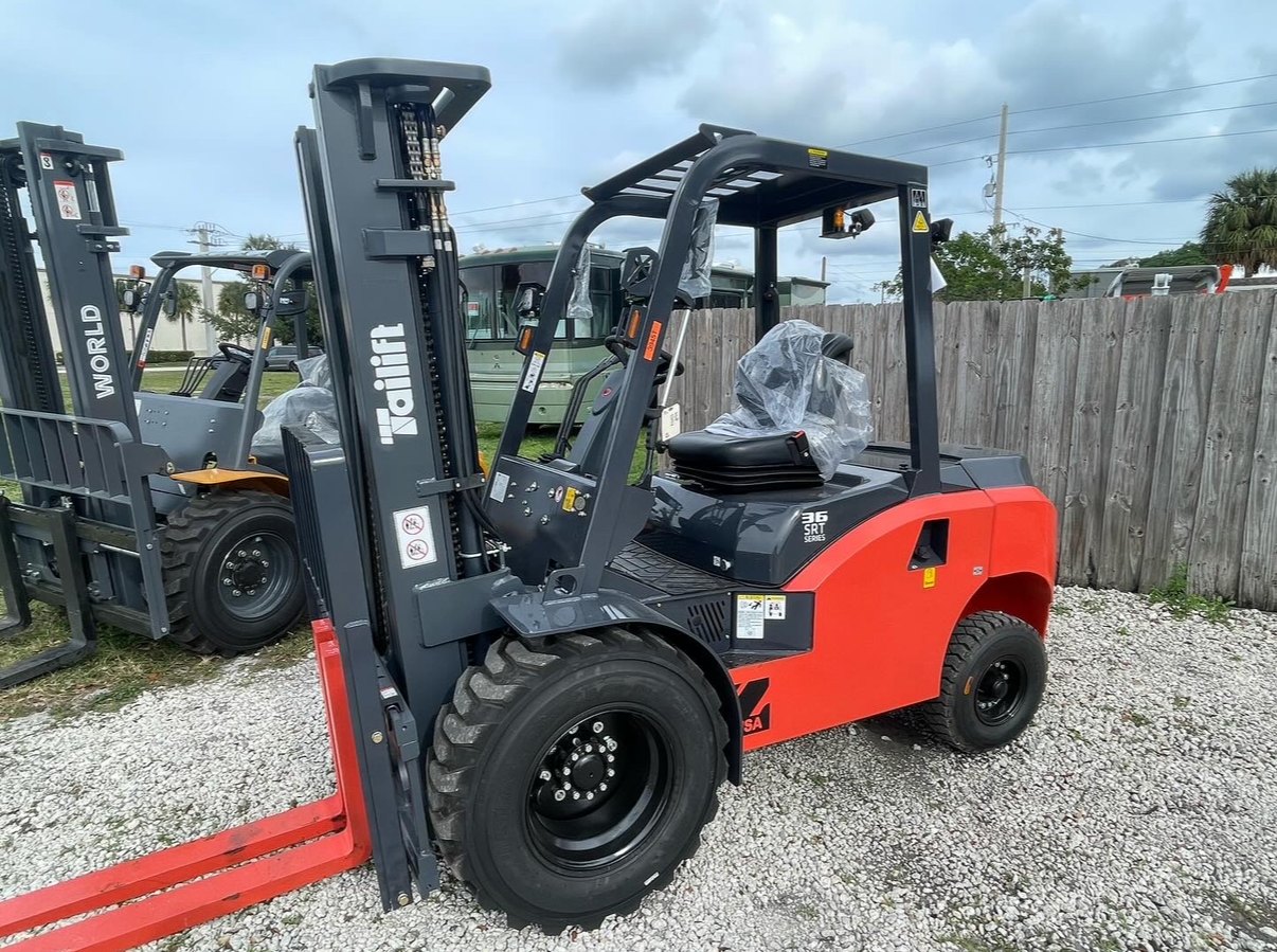 Tailift rough terrain diesel forklift with pneumatic tires on a gravel dealer lot