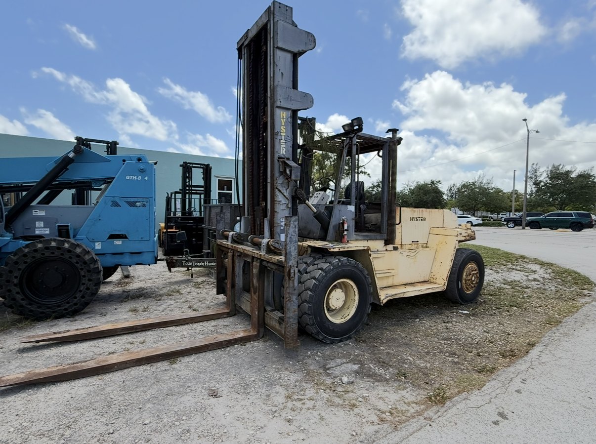 High-capacity Hyster pneumatic-tire forklift with long forks parked in an industrial yard