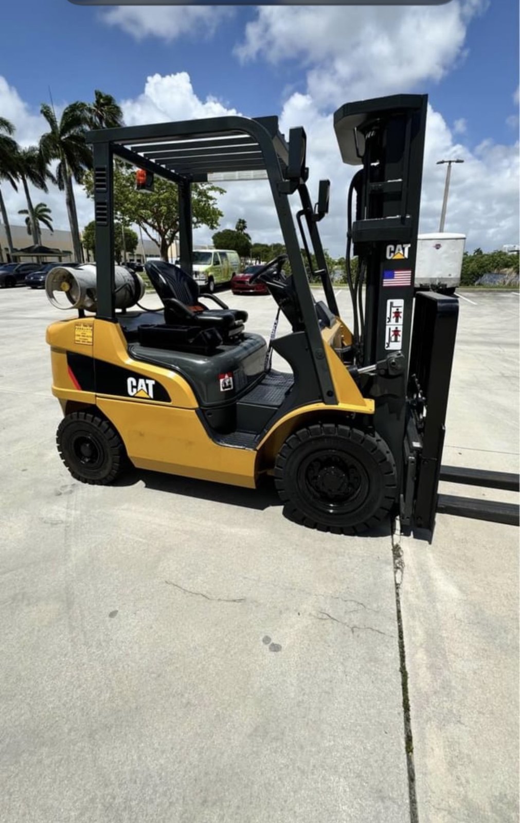 Clean late-model Caterpillar LP forklift with side-mounted propane tank on a paved South Florida lot